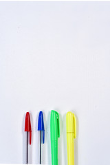 colorful ballpoint pens on white background