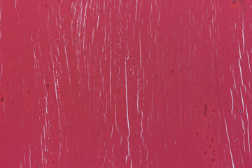 cracked red paint texture with pieces of exfoliated paint and peeping white background
