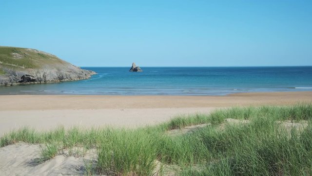 Looking out across sand dunes at Broad Haven South beach