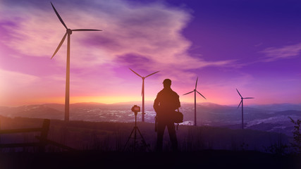 Fototapeta na wymiar Photographer with a tripod photographs the landscape with wind turbines at sunset