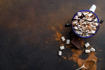 Gordijnen hot chocolate in an iron mug with marshmallow on dark rustic background. Copy space top view © bbivirys