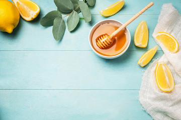 Honey, lemon slices and eucalyptus leaves. Top view image frame from ingredients, copy space, blue...