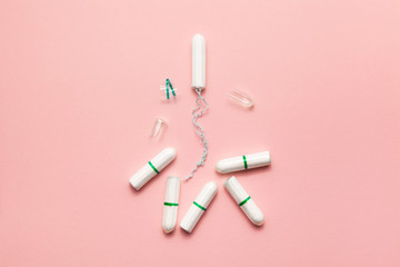 Unpacked tampons on a soft pink background. Modern female intimate gynecological hygiene. Eco zero waste concept. Copy spase place for text. Flat lay