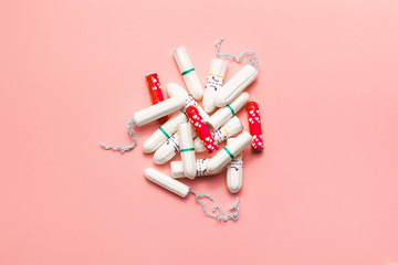 Heap of tampons on a soft pink background. Modern female intimate gynecological hygiene. Eco zero waste concept. Copy spase place for text. Flat lay