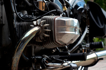 Obraz premium Eye level close up view of vintage, boxer style motorcycle engine, showing cylinder head, valve cover, and exhaust fins.