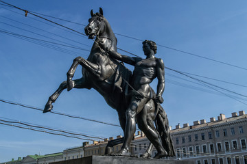 Fototapeta na wymiar Saint Petersburg, Russia - September 18, 2018: Horse tamers sculpture by Peter Klodt on Anichkov bridge built in 1841