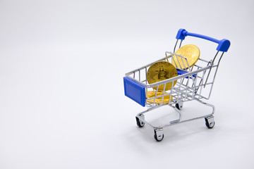 Gold Bitcoin coins, small carts Trading concept, business concept, financial investment concept.