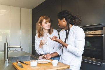 Mixed Race Couple Cooking Together in the Kitchen.