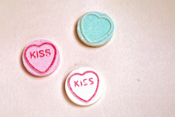 Round sweets with the inscription kiss in the heart close-up.