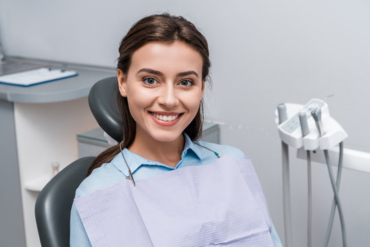 beautiful woman sitting and smiling in dental clinic