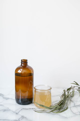 Amber Glass and Cup of Kombucha, Healthy Probiotic Drink, White and Marble Background, Copy Space