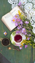 Breakfast with cup of tea and flowers on facebook jam rustic wooden background Top View