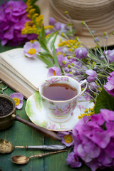 Breakfast with cup of tea and flowers on facebook jam rustic wooden background Top View