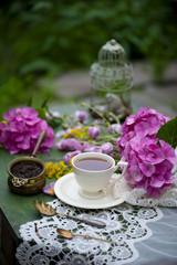 Breakfast with cup of tea and flowers on facebook jam rustic wooden background Top View
