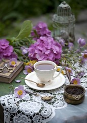 Obraz na płótnie Canvas Breakfast with cup of tea and flowers on facebook jam rustic wooden background Top View