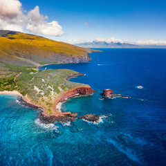 Aerial Drone view of Lāna'i Island, Hawaii, with Maui looming in the background.