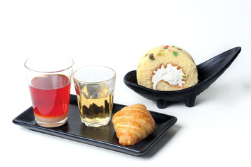 Thai Traditional milk tea served with tea ,croissant and roll fruit cake