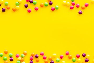 Sweets frame for pattern on yellow background top view copyspace