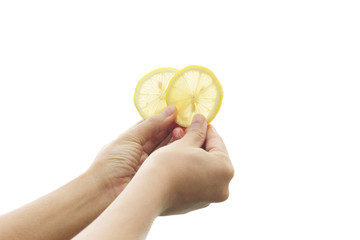 Women's hand of fresh lemon slices yellow on white background.