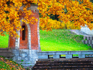 Fototapeta na wymiar Autumn in St. Petersburg. City Pushkin day. Tsarskoe selo. A tower of brick and trees with yellow leaves. Autumn park. nature of Russia. Petersburg Suburbs.
