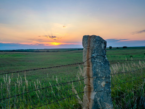 Limestone Post Fence On Green Pasture