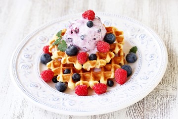 waffles with blueberries and raspberries and berry ice cream from yogurt.