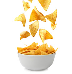 Ceramic bowl of Mexican nachos chips on white background