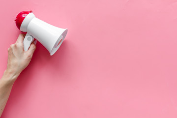 Attract attention with megaphone on pink background top view copyspace