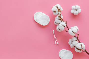 pattern of cosmetic cotton swabs and pads on pink background top view mockup