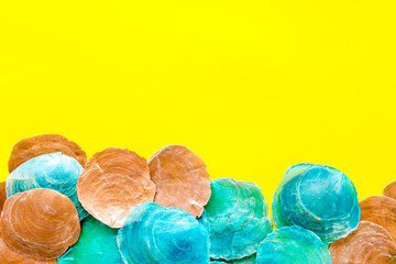 Shells frame on yellow background top view copyspace