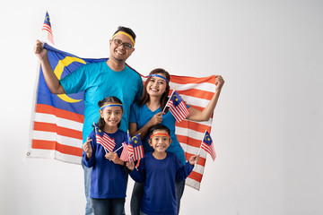 malaysia family with attributes and flag for celebrating independence day