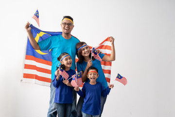 proud malaysian family holding malaysia flag over white background on independence day