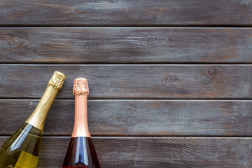 Party concept with champagne bottle on wooden background top view copyspace