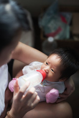 Obraz na płótnie Canvas Mother feeds Baby infant eating milk