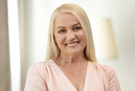 Portrait of happy mature woman at home