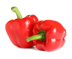 Tasty ripe red bell peppers on white background