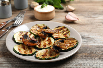 Grilled zucchini slices served on wooden table