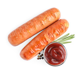 Delicious grilled sausages and sauce on white background, top view. Barbecue food