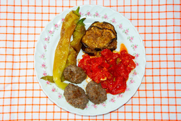 Turkish Fried Foods. Meatballs with fried eggplant, peppers and tomatoes