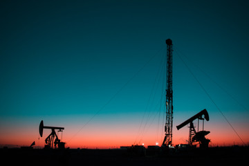 In the evening oil field, the pump is running.
