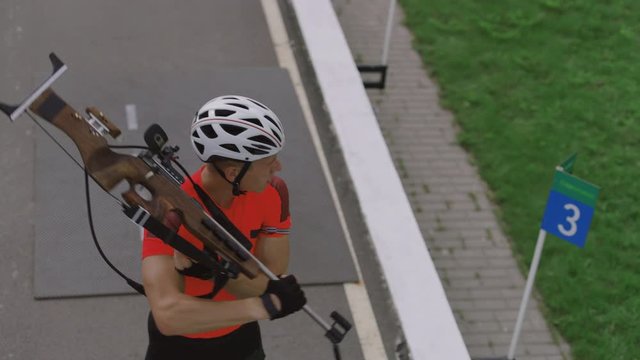 Portrait of Caucasian male professional biathlete practicing on a shooting range during mid-season practice in summer. ARRI Alexa Mini with Cooke S4 prime lenses RAW graded footage
