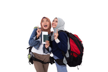 happy muslim two hijab woman carrying bagpack with isolated background