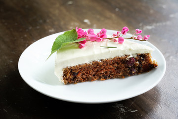 Delicious sliced carrot cake on wood table.