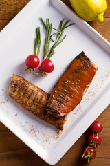 Grilled mackerel fish fillet in mustard sauce.  View from above, top studio shot