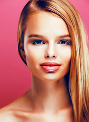 Fototapeta premium young pretty blonde real woman with hairstyle close up and makeup on pink background smiling, stylish fashion look like baby doll