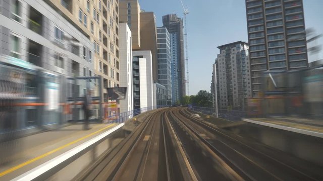 Overground train arriving at a city station.