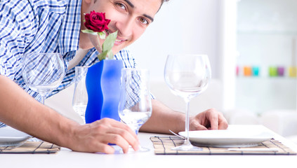 Man alone preparing for romantic date with his sweetheart