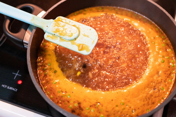 pumpkin tomato peas soup boiling in the pot on the stove