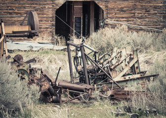 Fototapeta premium Old Machinery by an Abandoned Grain Elevator