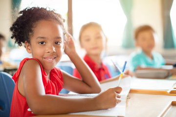 Smiling elementary school kids  in classroom